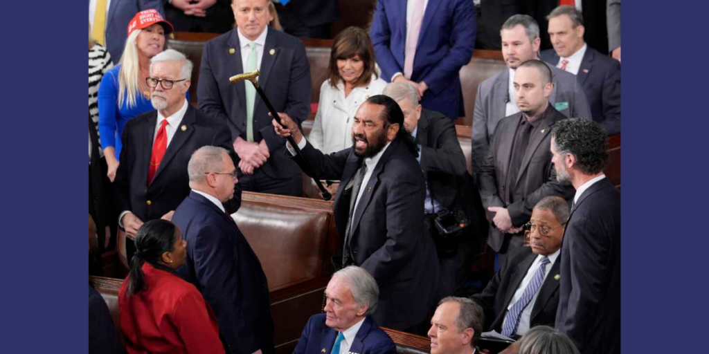 Congressman Al Green, a Texas Democrat, is escorted out of the U.S. House chamber by the sergeant-at-arms on March 4, 2025, after disrupting President Trump’s address with shouts and cane-waving, protesting proposed Medicaid cuts during a tense session in Washington, D.C.