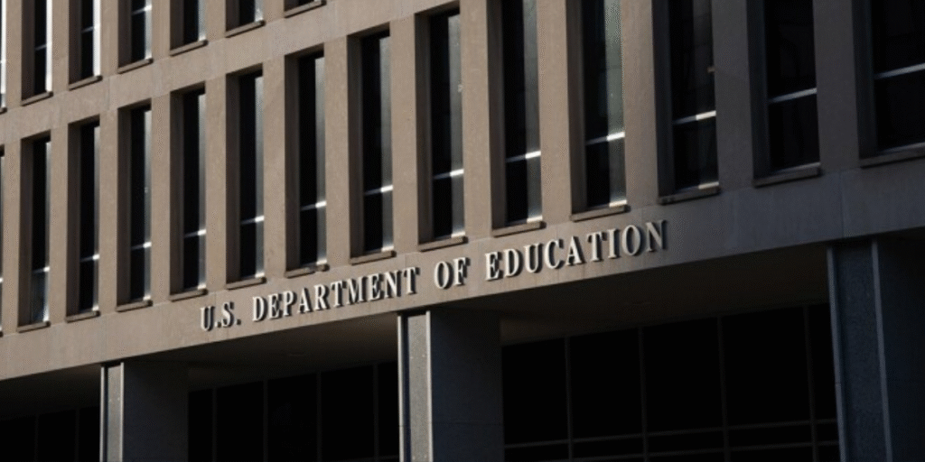 The U.S. Department of Education building in Washington, D.C., stands under a cloudy sky, with its sign prominently displayed, symbolizing the resumption of student loan collections on May 5.